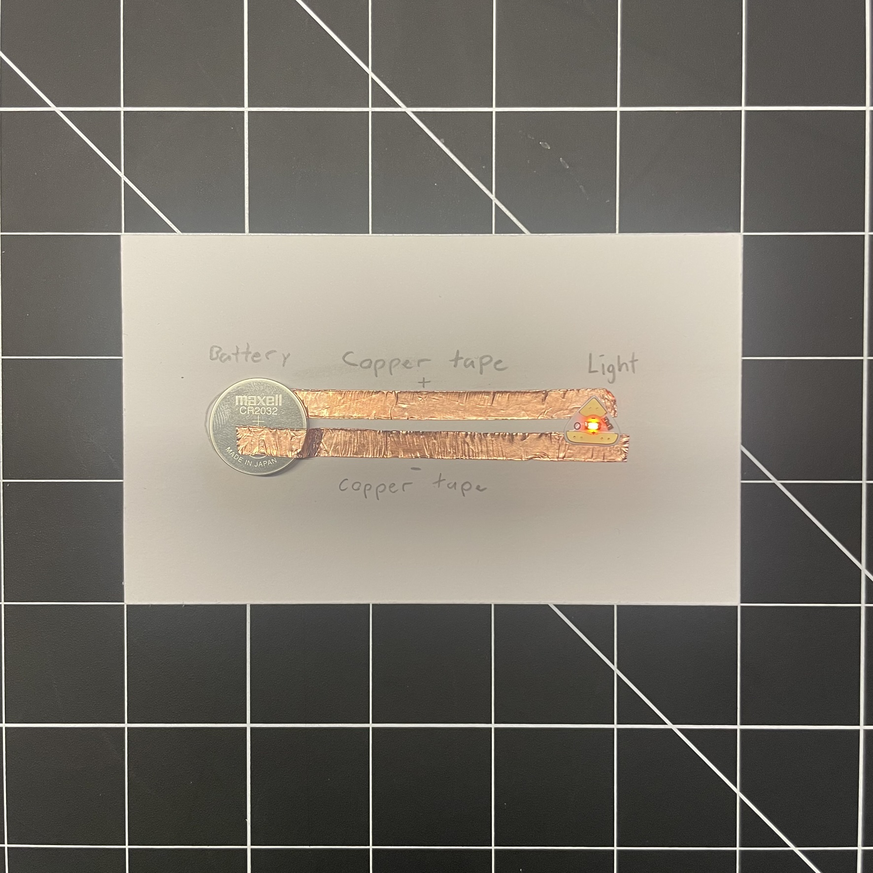 This is the working circuit with the tape on the top and bottom of the battery to activate the light