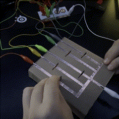 This is the ninth circuit, it is a coin slot circuit, the main conductor on the circuit is copper tape, but a quarter is used to complete the circuit to activate each of the makey makey buttons, when the coin is placed into one of the slots the button activates.